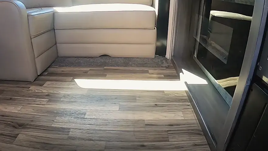 Slide-out room with a new plank floor, looking out through the open slide